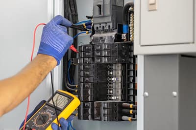 Electrician repairing electrical board in new jersey Luminous llc
